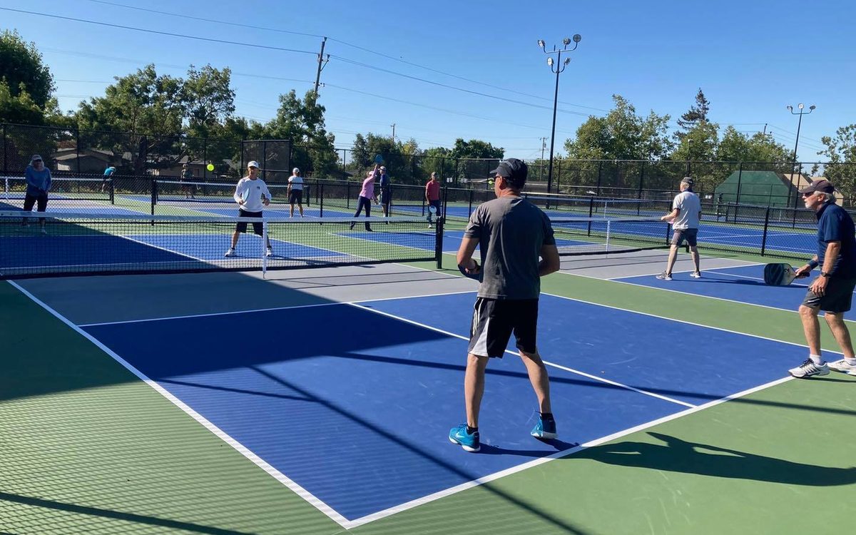 A doubles game underway on the dedicated pickleball courts at Lucchesi Park, Petaluma, ball in the air